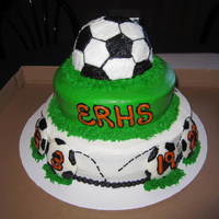Erhs Boys Soccer Cake! Chocolate, strawberry, and white cakes with buttercream. Soccer balls on bottom were white chocolate made with molds.