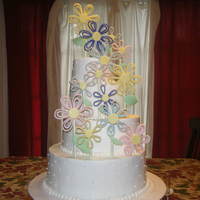Daisy Tiered Cake Four-tiered white wedding cake with white buttercream icing, and MMF daisies.