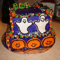 Pumpkin And Ghost Cake I made this cake for my mom's potluck supper for work around Halloween. It was my first-tiered cake. I used sugar cookies for the...