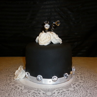 Black Birthday Cake I made this for my friends Bday. Vanilla cake with chocolate buttercream. Black MMF, white fondant roses. TFL