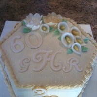 60Yh Anniversary Cake Ivory and white hexagon cake with the recipient's monogram, white and ivory gumpaste/fondant fantasy flowers and Calla Lillies. WASC...