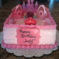 Princess Cake Princess castle cake with gumpaste/fondant castle, crowns, rose, butterflies and candy melt crowns. Chocolate cake with alternating layers...