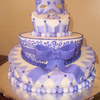 Purple Masquerade Fondant dummy cake 50/50 feathers and masque. I entered this in a contest at the fair (beginer) and it won 1st place and best of show.