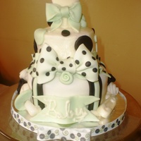 Baby Shower This was a sample cake. MMF bottom tier, buttercream top layer. fondant accents and chocolate rattle topper