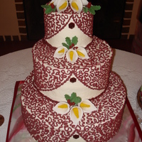 My Dad's Wedding Cake Three tier champagne cake with champagne buttercream (it took 2.5 bottles of champagne to make this cake!) Gumpaste calla lillies and holly...