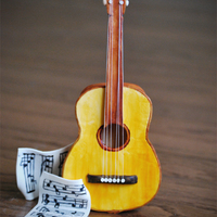 Gum Paste Guitar Guitar made of entirely of gum paste with the exception of the strings (thread). Music sheets are gum paste with hand painted notes....