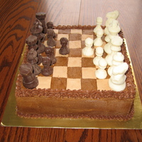 Chocolate Chess Cake 8" square cake, chocolate molded chess pieces on a buttercream chess board