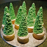 Christmas Tree Cupcakes :) These are cupcakes I made for a Christmas party. It's ice cream cones covered with green buttercream icing, silver balls and sprinkled...