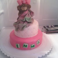 Baby Monkey Baby shower cake for a little girl. The monkey is all buttercream with a fondant diaper and gumpaste blanket.