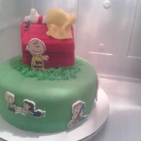 Peanuts all characters on the side are hand drawn on rice paper stuck to fondant with edible markers.