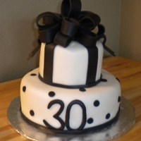 Black And White 30Th Birthday Cake Vanilla cake with buttercream icing and White fondant with black accents.