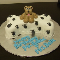 Dog Bone Cake This is a cake I made for my dogs' birthday. (its not for them... haha) Its covered in MMF and the dog and paw prints are made out of...