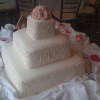 Tara This cake was decorated to mock the look of the wedding invitation which had very detailed scrollwork throughout. I piped a like design on...