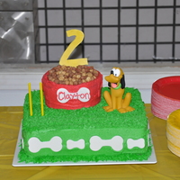 Pluto Birthday Cake pluto themed birthday party. White cake, raspberry mouse filling. Buttercream icing, gumpaste bones, Dog food is Reese's Puffs cereal...