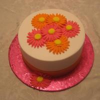 Gerbera Orange & pink gerbera daisies, fondant ribbon.