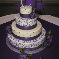Purple Wedding Cake four tier round wedding cake with diamond impression and scrolls.