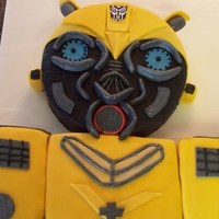 Transformers Bumble Bee Made for a 4 year olds birthday who loves bumble bee.Covered in buttercream and fondant.Chocolate cake filled with bavarian cream.TFL