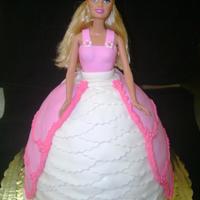 Pink Barbie white cake with buttercream filling. fondant and royal icing accents