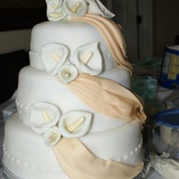 Tan And White Cake Pound cake w/ guava filling, covered w/ fondant. Gumpaste flowers