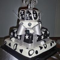 Black And White Theme This is a black and white theme wedding cake. The bride wanted a LV bag as a topper and I think it worked wonderful. 100% edible with MM...