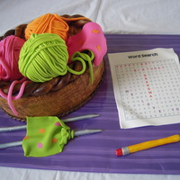 Knitting Cake Knitting basket with balls of yarn, knitting needles, and an edible word-search birthday card with gumpaste pencil for a grandmother's...