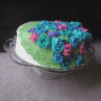 Flower Bouquet Rich chocolate cake covered in buttercream icing. The flowers are also made of colored buttercream (rose, violet, sky blue, royal blue, and...