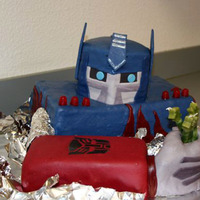 Optimus Prime Transformer Cake MMFcovered cake, crispie rice cereal treat sculpted hand also covered in MMF