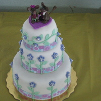 My First Fondant Cake This a fondant cake with flowers and mices and fondant too.