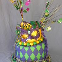 Mardi Gras Mardi Gras topsey-turvey birthday cake. White cake with buttercream filling, covered and decorated in fondant.