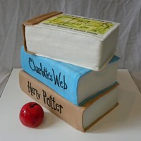 Stack Of Books Covered in fondant, edible image on top book, apple is fondant and painted with food coloring.
