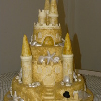 Sand Castle Wedding Cake 4-tier sand castle wedding cand with everything edible! The shells and tops of the turrets are chocolate and the sand is raw sugar! Cakes...