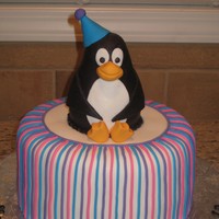 Penguin! 8" round, covered in fondant. Penguin made from RKT & covered with fondant as well. I thought the little penguin came out super...