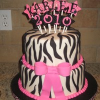 Graduation Cake! 8 & 10 inch rounds, WASC (tie-dyed). Covered in MMF with fondant zebra stripes. Gumpaste stars, letters/numbers and bow. Buttercream...