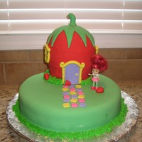 Strawberry Shortcake's House! Cake made for my niece's birthday. Bottom is 1 10" round, torted. Strawberry is 2 6" rounds, with 1/2 ball pan on top....