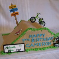 Bmx Track (Table Top) Cake I made this cake for a friend's son, who races BMX. Personalized cake with mohawk helmet and name placard.