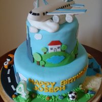 4Th Birthday Cake I put everything my 4 year old son loves in this cake: airplane, soccer ball, cars, construction truck, bricks, beach, sand, rocks, shovel...