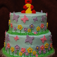 Girly Elmo Birthday Cake Iced in buttercream with fondant accents. Elmo and the number 2 were made from Fondant.
