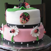 Lady Bugs Daisies with lady bugs. This cake was made for baby shower. All red velvet with cream cheese filling. All was made fondant.