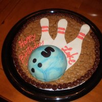 Bowling Party Cookie Cake This was a giant cookie cake. The pins were cut from fondant and the bowling ball is krispie treats covered with fondant. The bowling ball...