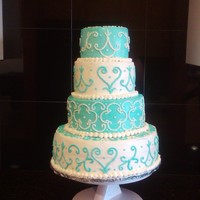 Blue Wedding Cake This cake is alternating layers of Chocolate and vanilla cake with butter cream frosting and scrolls