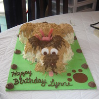 Puppy Buttercream frosting with fondant accents. lol The poops were chocolate macaroons... The tongue is gum and the bow is a sour gummy ribbon...