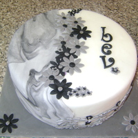 Flower/marble 8inch sponge. fondant with grey and black daises.