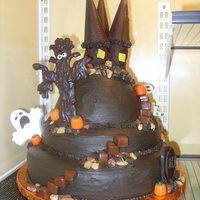 Haunted Castle 3 tier haunted castle... all edible. Tree is stacked marshmallows covered in chocolate, towers are tootsie rolls (3 large) rolled with dark...
