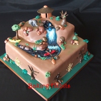 Kayak/safari Cake Chocolate cake with chocolate buttercream covered in rolled brown fondant. Everything is edible.