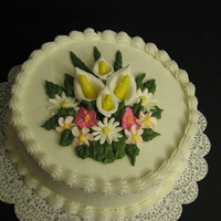 Floral Bouquet White cake with butter cream icing with royal icing and gumpaste flowers.