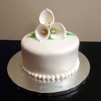 Calla Lillies Chocolate cake with chocolate buttercream icing and covered in homemade marshmallow fondant. Flowers are 50/50 blend of gumpaste and...