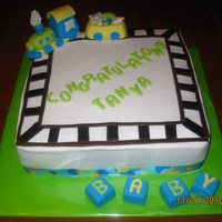 Baby Shower Train White cake with ultra vanilla buttercream filling and vanilla buttercream exterier. Toppers made with fondant and gumpaste.