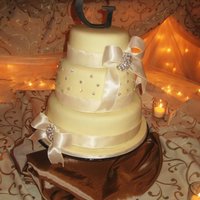 Bling And Ribbon Wedding Cake 10/8/6 inch - flavors include: Chocolate with Caramel Buttercream filling, Lemon with Raspberry Buttercream filling, Strawberry with...