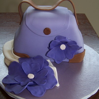 Purple Purse With Fantasty Flowers I did this cake for a woman's 50th birthday. I was told the birthday girl loved purses, purple, and flowers - so this is what I came...