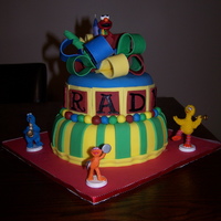 Sesame Street Cake Birthday cake for a 2-year-old boy named Brady (hard to tell tell because name wraps around the cake). Client provided the figurines and...